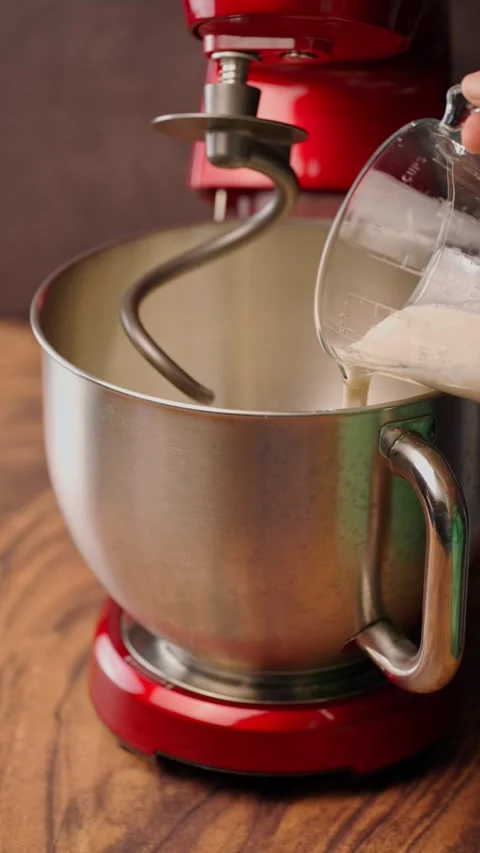 Vertical video, adding yeast with a glass measuring cup Stock Footage 282499587