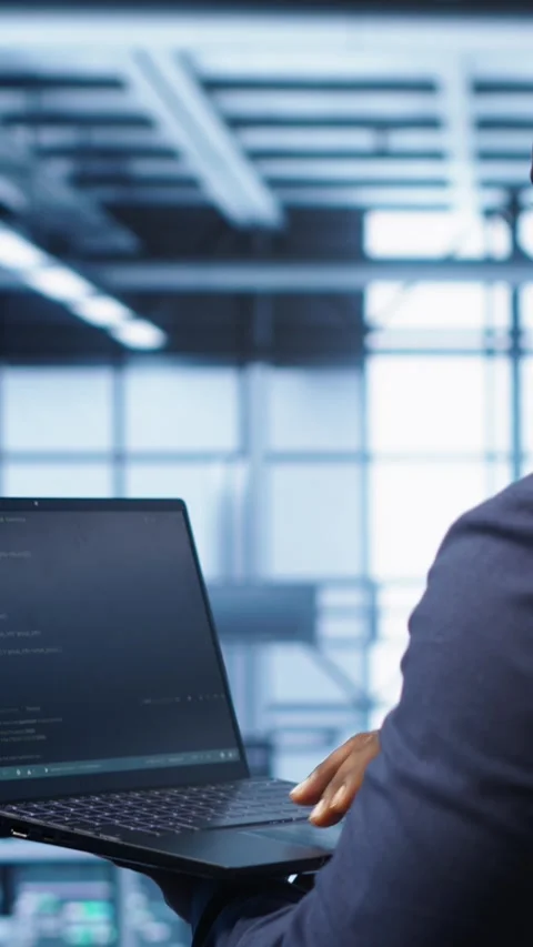 Vertical video Admin in data center running error checking utilities on tablet Stock Footage 277857334