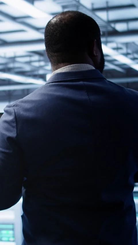 Vertical video Admin in data center running error checking utilities on tablet Stock Footage 277858347