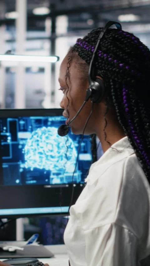 Vertical video Admin in data center wearing headset assisting users with AI Stock Footage 313455922