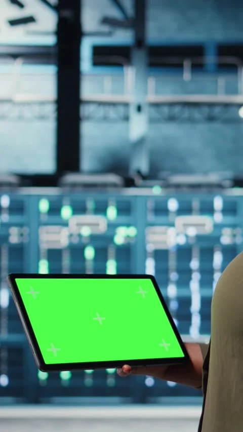 Vertical video Admin in data center using green screen tablet to deploy new Stock Footage 316850589