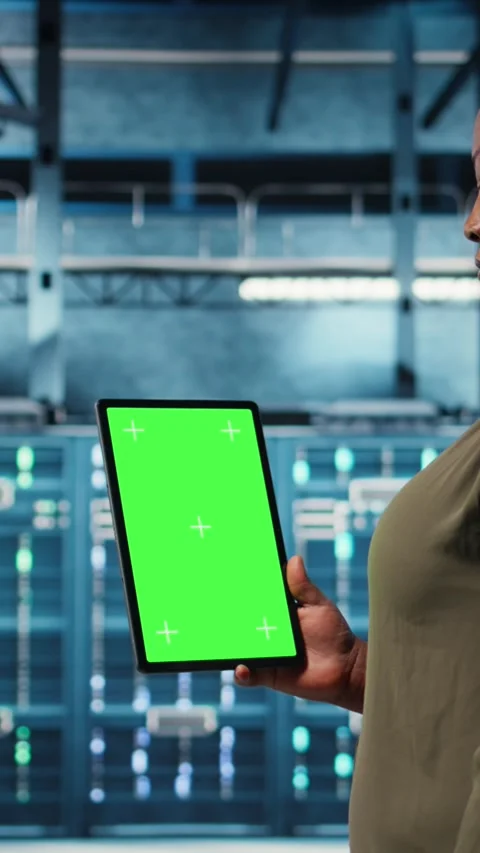 Vertical video Admin with isolated screen tablet in data center doing power Stock Footage 317055126