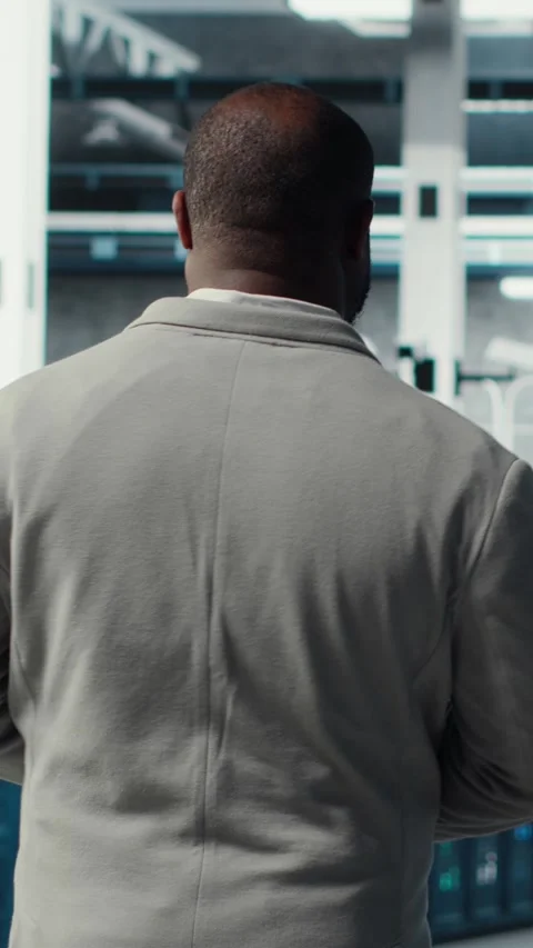 Vertical video Admin walking in data center, doing inspection on infrastructure Stock Footage 311548046