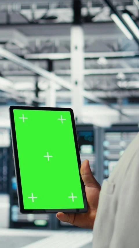 Vertical video Admin working in server farm using isolated screen tablet to Stock Footage 311412482