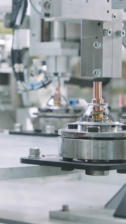 Vertical video of Advanced robotic machine manufacturing parts in an automated Stock Footage 206320196