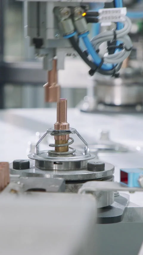 Vertical video of Advanced robotic machine manufacturing parts in an automated Stock Footage 206321183