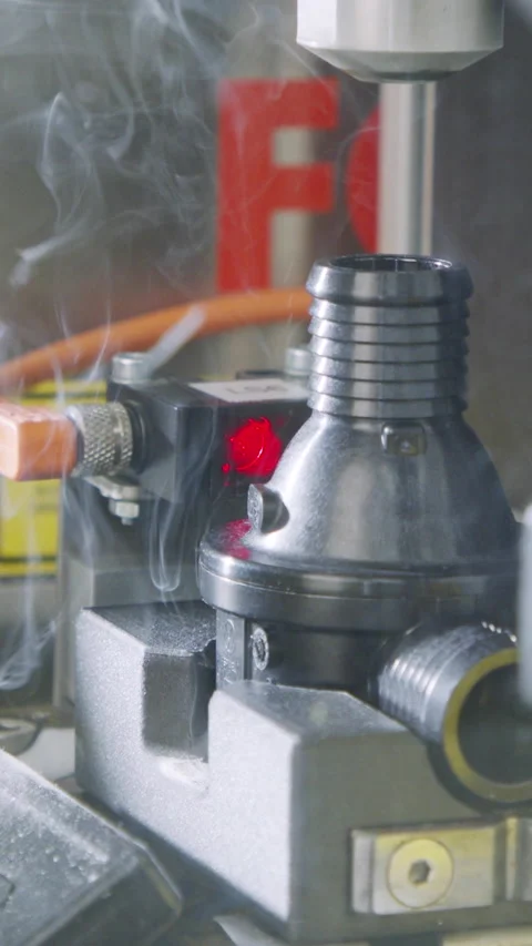 Vertical video of Advanced robotic machine manufacturing parts in an automated Stock Footage 206327785