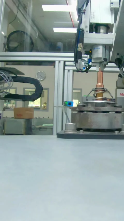 Vertical video of Advanced robotic machine manufacturing parts in an automated Video stock 206329823