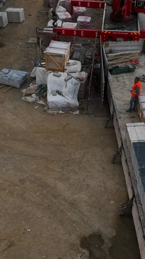 Vertical Video: Aerial Construction Progress - Crane Unloading Cargo with Stock Footage 245192804