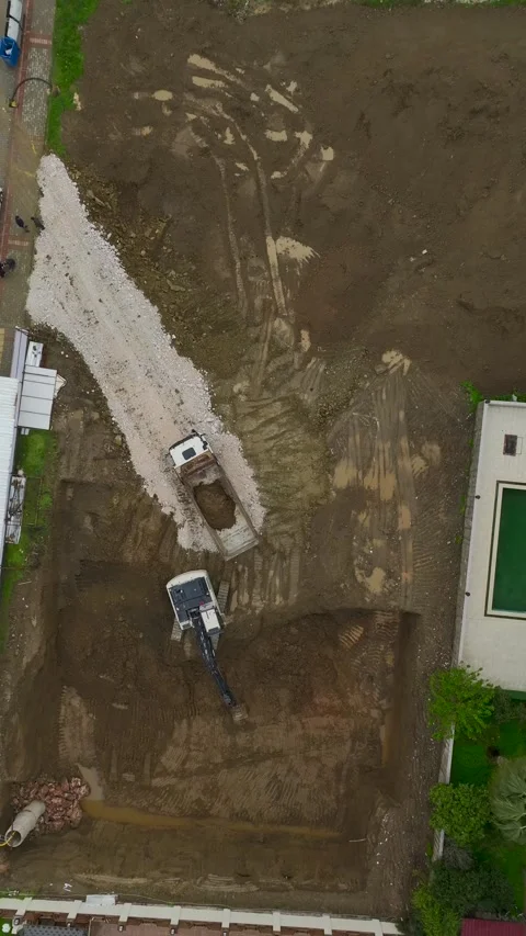 Vertical Video Aerial Earthworks Process with Excavator and Dump Truck Stock Footage 342429468