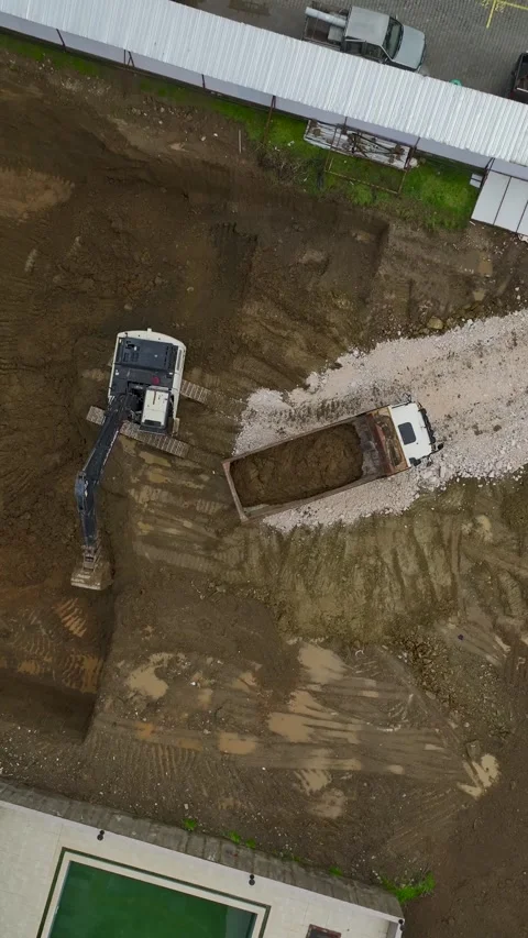 Vertical Video Aerial Excavation Process with Dump Truck Receiving Soil Load Stock Footage 342430649