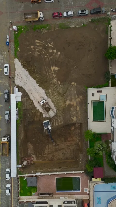 Vertical Video Aerial Excavator Loading Truck on Foundation Preparation Site Stock Footage 342429285
