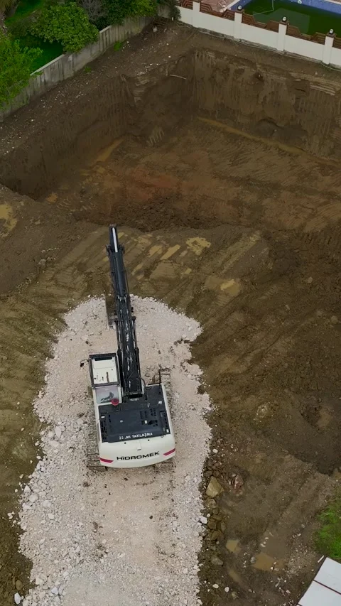 Vertical Video Aerial Excavator Operating Near Residential Complex Construction Stock Footage 342426134