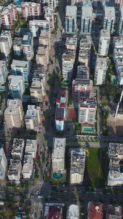 Vertical Video: Aerial Perspective of City Buildings Overlooking the Ocean and Stock Footage 342654746