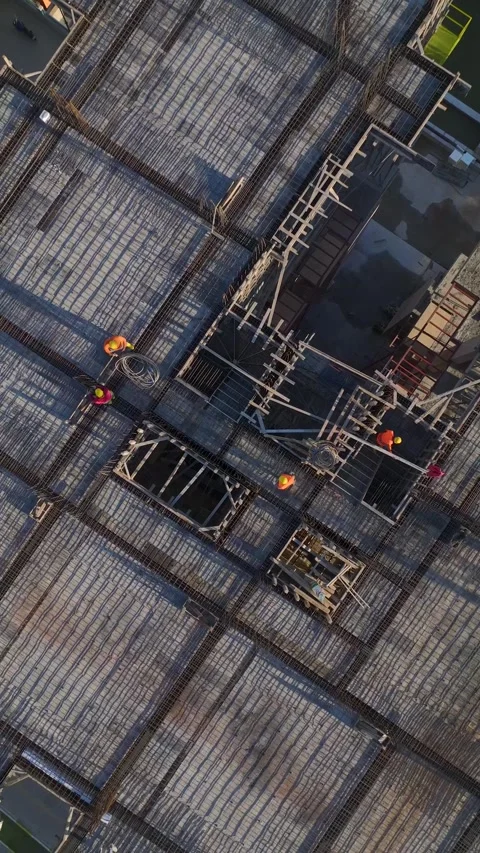 Vertical Video: Aerial Perspective of Construction Workers Completing Stock Footage 342567627
