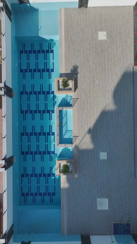 Vertical Video: Aerial Perspective of an Empty Pool in a Resort or Residential Stock Footage 342908670