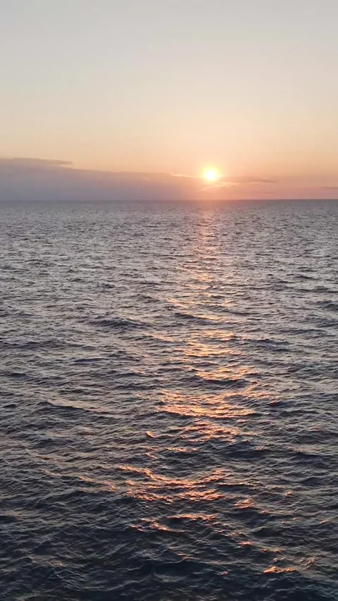 Vertical Video: Aerial Perspective of Shimmering Ocean Texture at Sunset With a Stock Footage 342591159