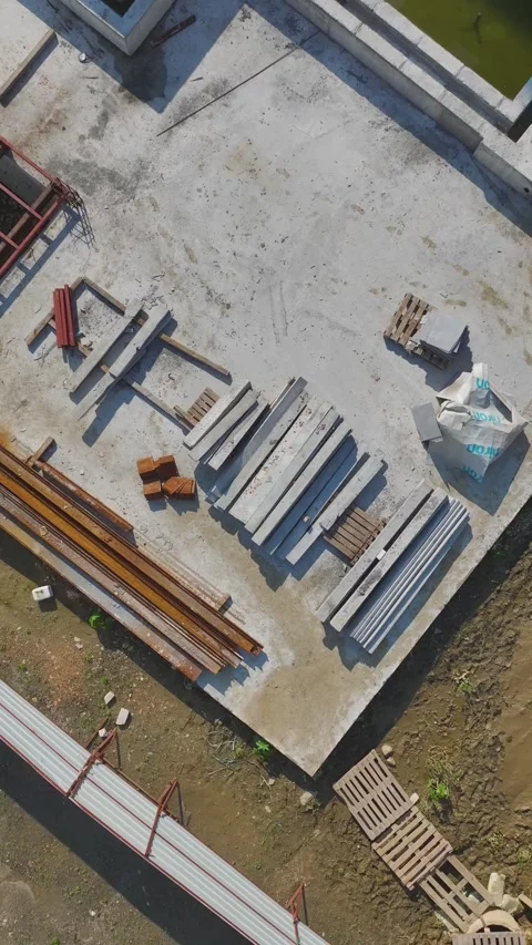 Vertical Video: Aerial Perspective of Teams Handling Tools and Materials on a Stock Footage 342907853