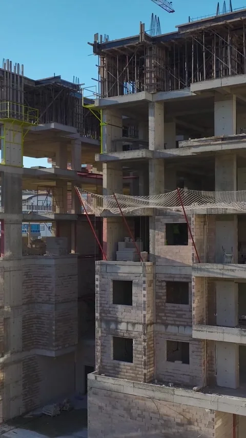 Vertical Video: Aerial Perspective of Workers on Scaffolding Preparing New Stock-Footage 342569192