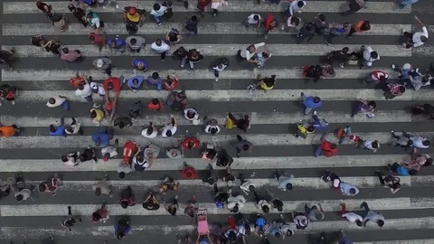 Vertical Video with aerial top view of a busy crosswalk intersection Stock Footage
