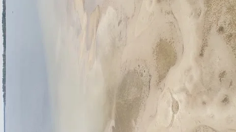 Vertical video. Aerial view. Approaching the shoreline of a large lake. Video stock 260486658
