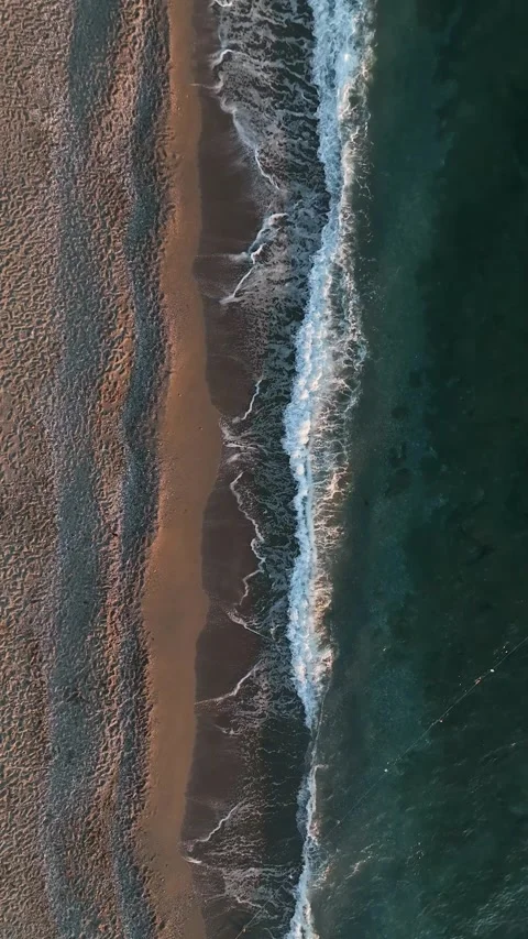 Vertical video aerial view of the evening beach, sea texture in the Stock Footage 231482214