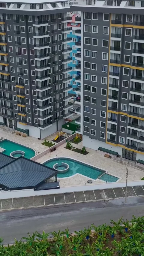 Vertical Video: Aerial view of luxurious residential complexes with blue pools Stock Footage 297637166