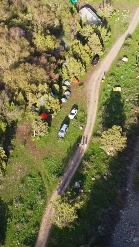 Vertical video: Aerial View of Remote Mountain Base Camp and SUVs Video stock 331790563