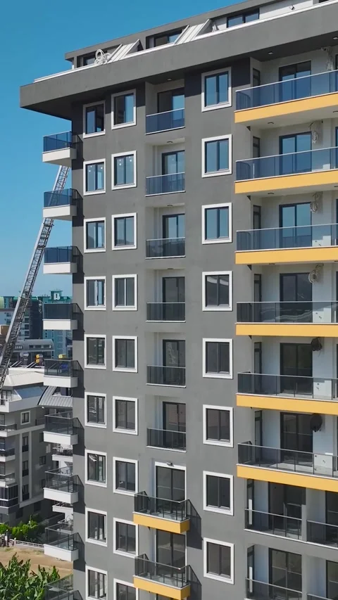 Vertical Video: Aerial View of Workers Handling Metal, Installing Facades, and Stock Footage 297753033