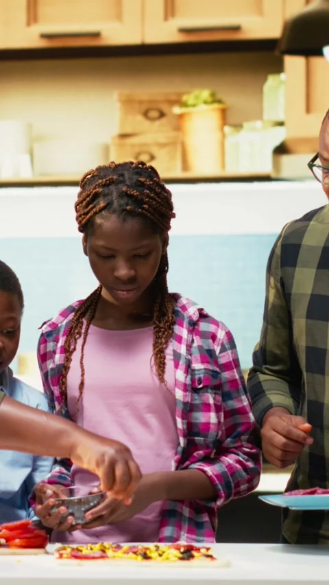 Vertical Video African American cute family laughing while preparing homemade Stock Footage 319876643