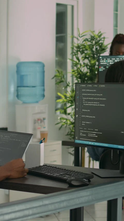 Vertical video: African american developer using laptop to write code and 動画素材 218575714