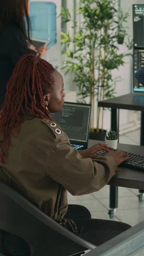 Vertical video: African american programer typing source code on computer Stock Footage 218574870