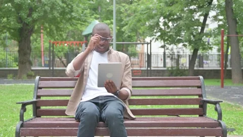 Vertical Video, African Man Expressing Disbelief While Using a Tablet Video stock 310833620