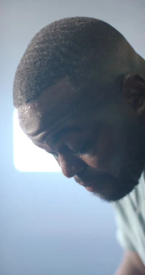 Vertical video: African man hand wiping sweat after workout breathing near Stock Footage 345218661