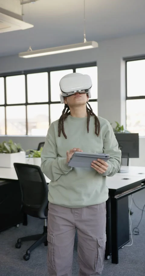 Vertical video: African nonbinary tech VR starting, testing tablet UI while Stock Footage 344695613