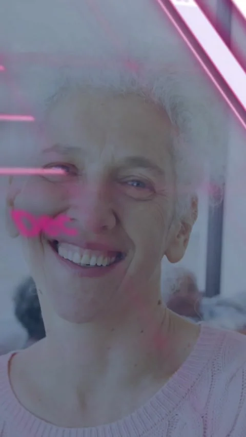 Vertical video: After refresh, senior woman smiling, pink HUD sliding over face, Video stock 330605128