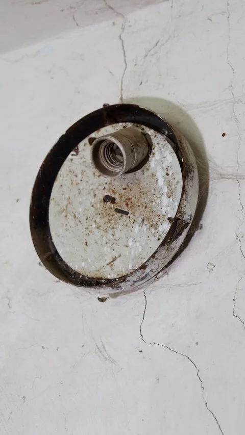 Vertical video. Aged ceiling with cobwebs, cracks and a metal light fixture Video stock 294670976