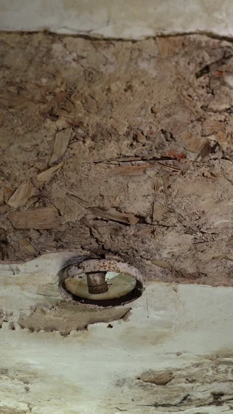 Vertical video. Aged ceiling with visible cracks and a metal light fixture Stock-Footage 294671287