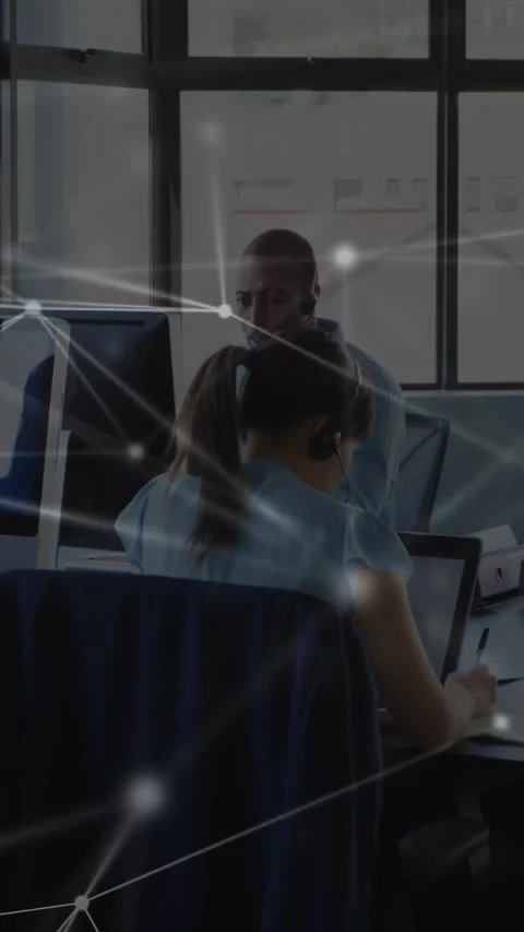 Vertical video: Agents on support call, woman typing, man speaking, network Stock Footage 332317536