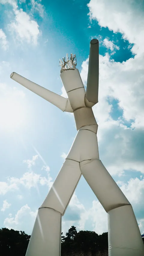 Vertical video of air white dancer against sunny blue sky with clouds. 스톡 동영상 310005776