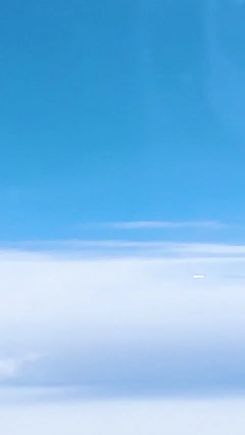 Vertical video of airplane flying through clouds seen through window of anoth 스톡 동영상 220652390