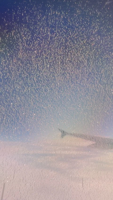 Vertical video. Airplane Wing seen through Window with Dense Droplet Pattern and Stock Footage 323652224