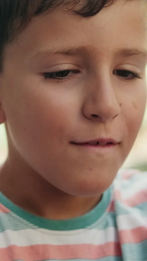 Vertical video, Amazed Boy Looking Down in Slow Motion Stock Footage 310450497