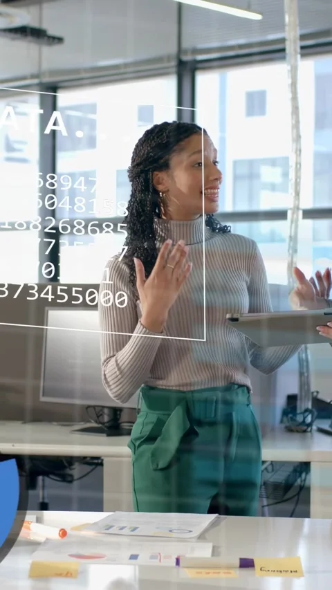 Vertical video: Analyst pointing at tablet, tablet activating data charts on Stock Footage 334770396