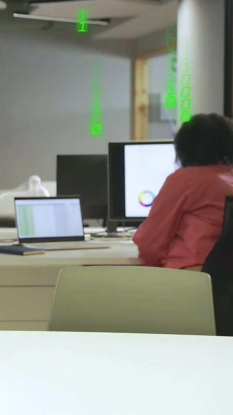 Vertical video: Analyst reviewing sheet while green code falling and drawing Stock Footage 334378402