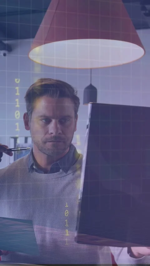 Vertical video: Analyst studying docs causing binary grid, leaning to screen, Stock Footage 333839889