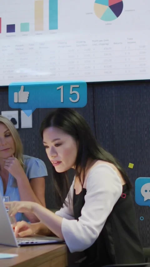 Vertical video: Analyst typing laptop making icons floating over charts in biz Видео 329912824