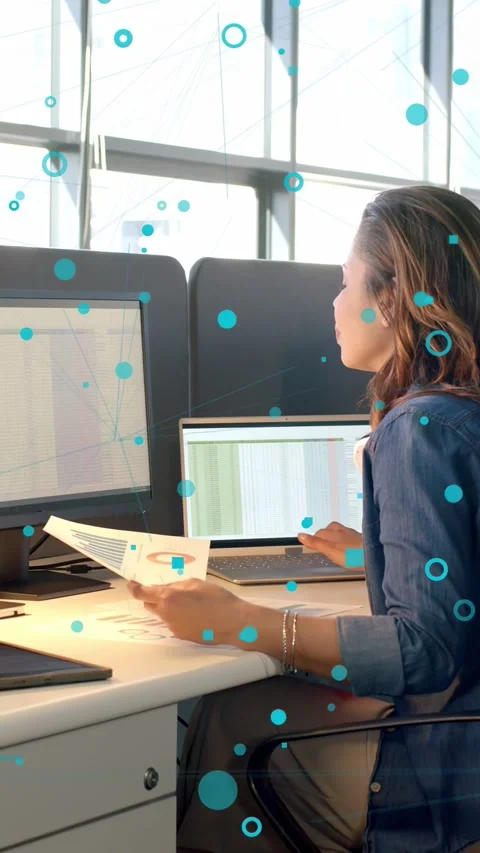Vertical video: Analyst using pad comparing business data to print charts, blue Stock Footage 333487060