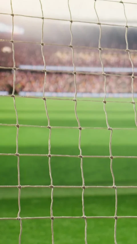Vertical Video Angled soccer goal net and side post framing empty green pitch Stock Footage 338046750