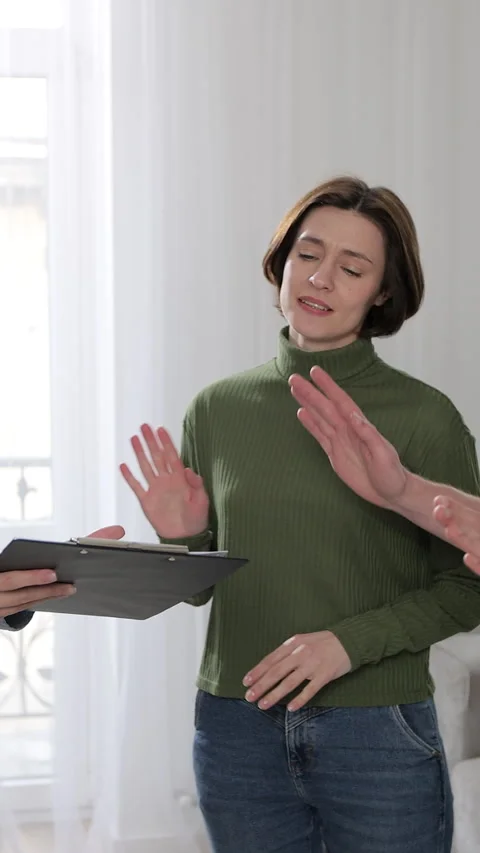 Vertical video. Angry couple with real estate agent visiting apartment Stock Footage 346201289